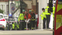 <p>In this image made from video, a woman with blankets wrapped around her is being escorted by emergency services near the scene of an explosion in London Friday, Sept. 15, 2017. (Photo: Sky via AP) </p>