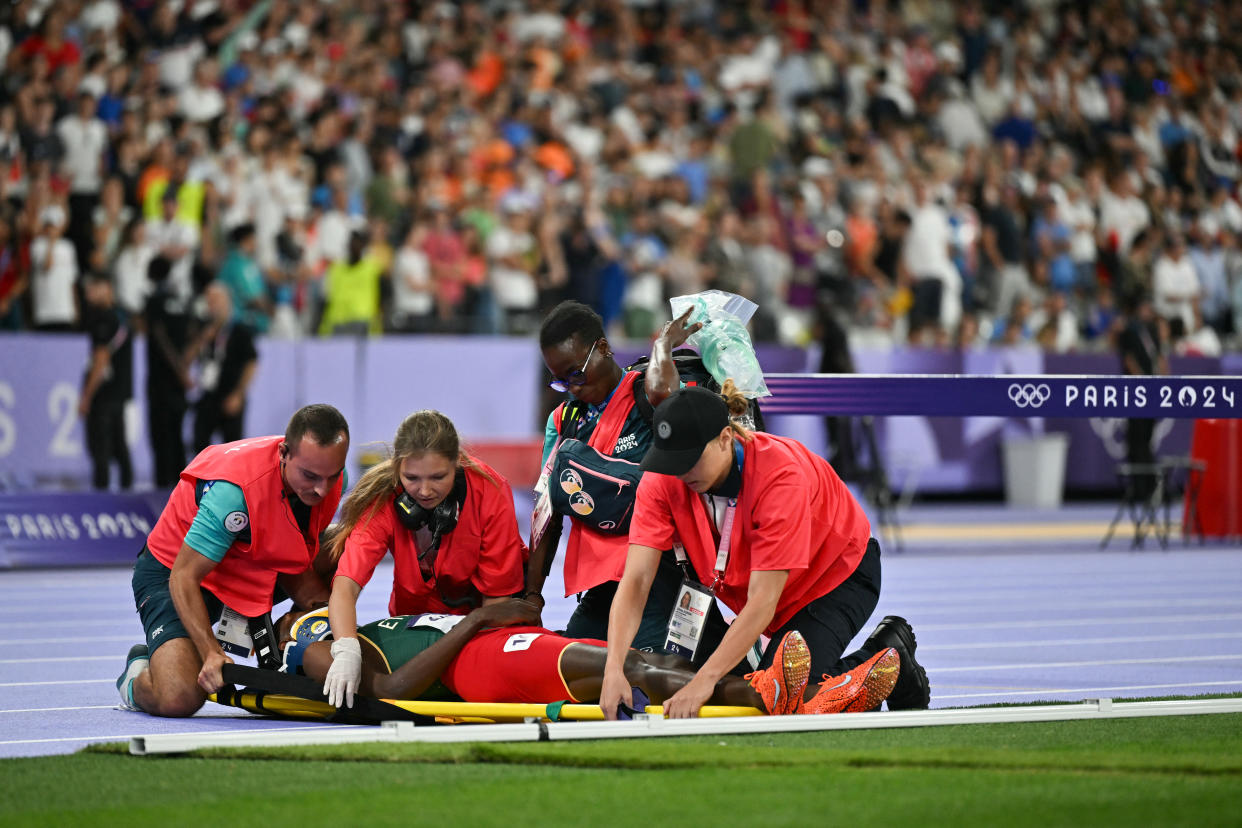 Ethiopia's Lamecha Girma receives medical attention during the men's 3000m steeplechase final of the athletics event at the Paris 2024 Olympic Games at Stade de France in Saint-Denis, north of Paris, on August 7, 2024. (Photo by Andrej ISAKOVIC / AFP) (Photo by ANDREJ ISAKOVIC/AFP via Getty Images)