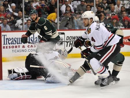 May 5, 2015; Saint Paul, MN, USA; Minnesota Wild forward Mikael Granlund (64) takes a shot against Chicago Blackhawks goalie Corey Crawford (50) during the second period in game three of the second round of the 2015 Stanley Cup Playoffs at Xcel Energy Center. Mandatory Credit: Marilyn Indahl-USA TODAY Sports