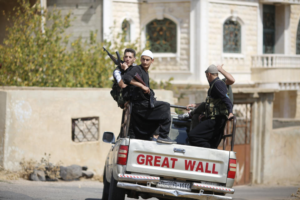 In this Thursday, Oct. 4, 2018, photo, young Druze armed men, patrol the village of Rami in the southern province of Sweida, Syria. Three months after a stunning Islamic State attack on a southeastern corner of Syria in which more than 200 people were killed and 30 women and children abducted, tensions are boiling over, and young men are taking up arms. It is a stark change for a province that managed to stay on the sidelines of the seven-year Syrian war and where most villagers worked grazing livestock over surrounding hills. (AP Photo/Hassan Ammar)