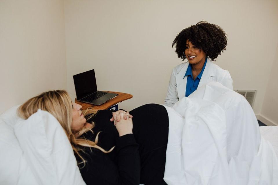 Justina Perry, right, chats with a patient at Oshun Physical Therapy and Pelvic Health.