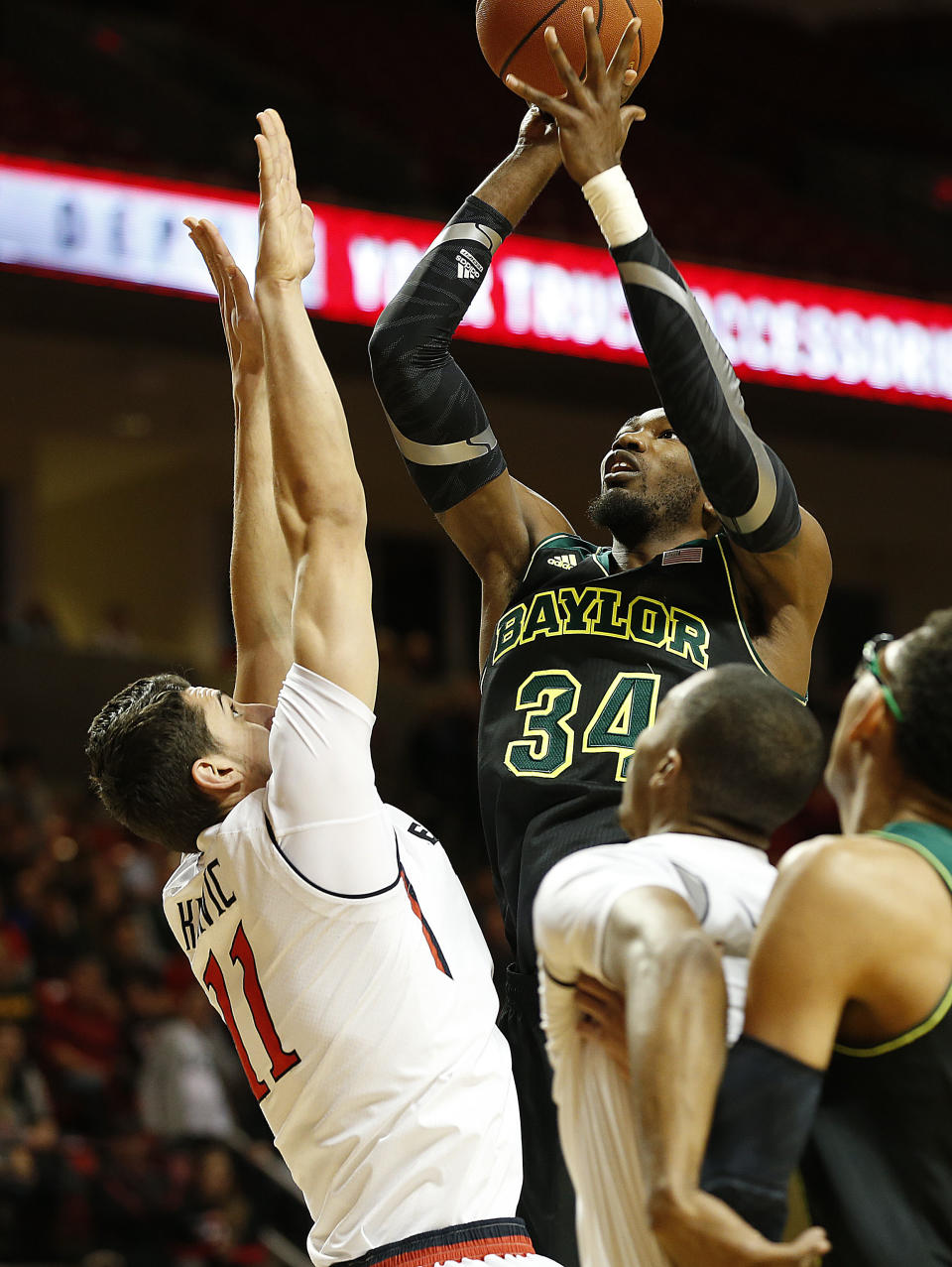 Baylor's Cory Jefferson shoots over Texas Tech's Dejan Kravic (11) during an NCAA college basketball game in Lubbock, Texas, Wednesday, Jan, 15, 2014. (AP Photo/Lubbock Avalanche-Journal, Tori Eichberger) ALL LOCAL TV OUT