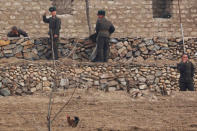 North Korean soldiers react as a boat sails from the Chinese side of the Yalu River, north of the North Korean town of Sinuiju and Dandong in China's Liaoning province, March 30, 2017. REUTERS/Damir Sagolj