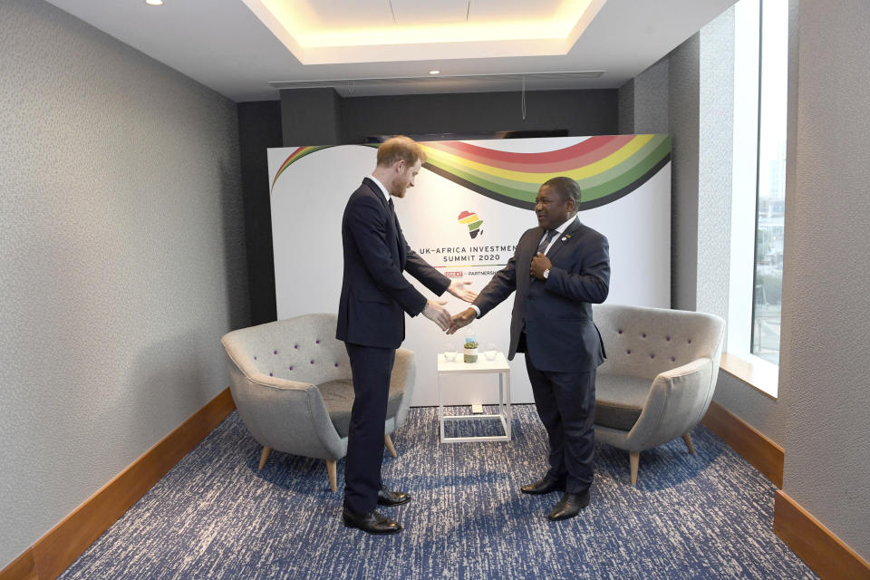 Britain's Prince Harry meets Filipe Nyusi, President of Mozambique, at the UK Africa Investment Summit in London, Monday Jan. 20, 2020. Boris Johnson is hosting 54 African heads of state or government in London. The move comes as the U.K. prepares for post-Brexit dealings with the world. (Stefan Rousseau/Pool via AP)