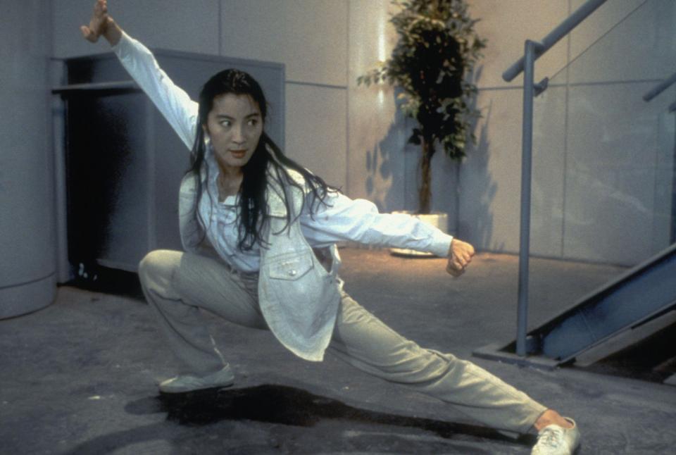 Michelle Yeoh prepares for a fight by posing in a defensive stance