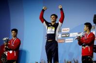 Diving – 17th FINA World Aquatics Championships – Men's 10m Platform awarding ceremony – Budapest, Hungary – July 22, 2017 – Tom Daley (C) of Britain (gold) reacts after winning. REUTERS/Stefan Wermuth