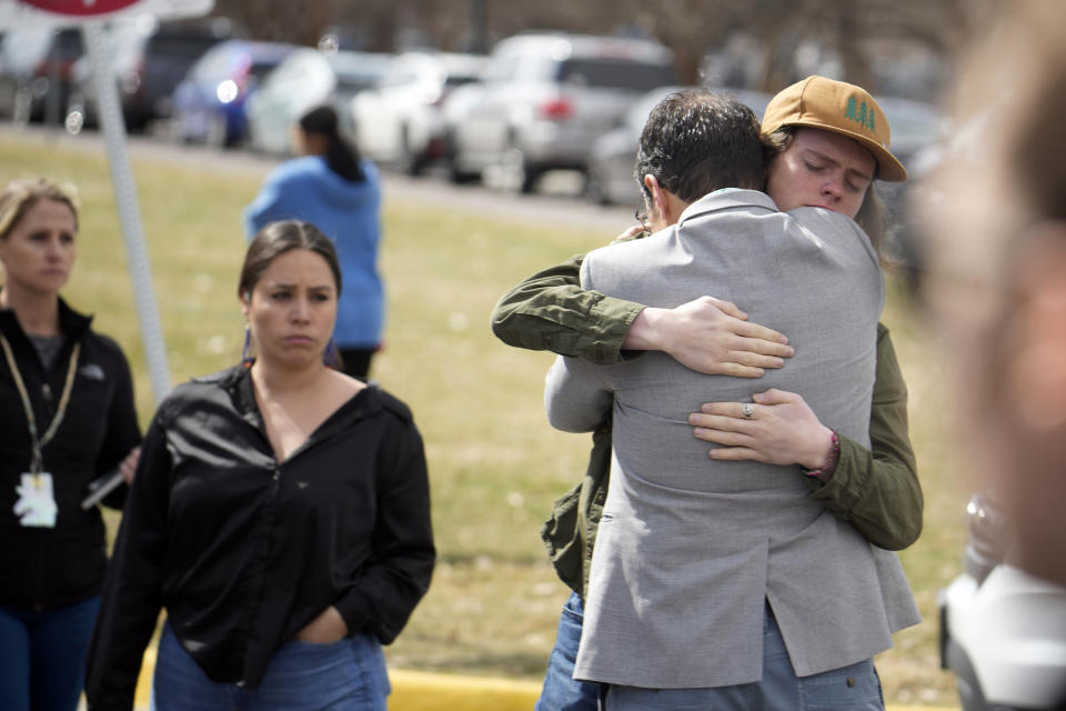 A student, right, hugs a parent as they are reunited following a shooting at East High School, Wednesday, March 22, 2023, in Denver. (AP Photo/David Zalubowski)