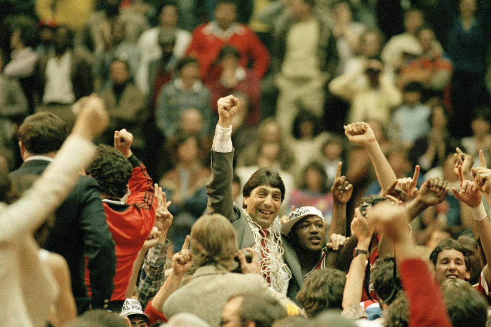 FILE - In this April 4, 1983, file photo, North Carolina State coach Jim Valvano, center with fist raised, celebrates after his basketball team defeated Houston to win the NCAA Final Four championship in Albuquerque, N.M. To this day, North Carolina State's Dereck Whittenburg jokes that his deep jumper that came up woefully short against Houston in the 1983 title game was really a perfect pass. Regardless, the Wolfpack's Lorenzo Charles was in the perfect spot to make the catch, drop the ball through the net and send Jim Valvano racing across the court like a mad man. (AP Photo/File)