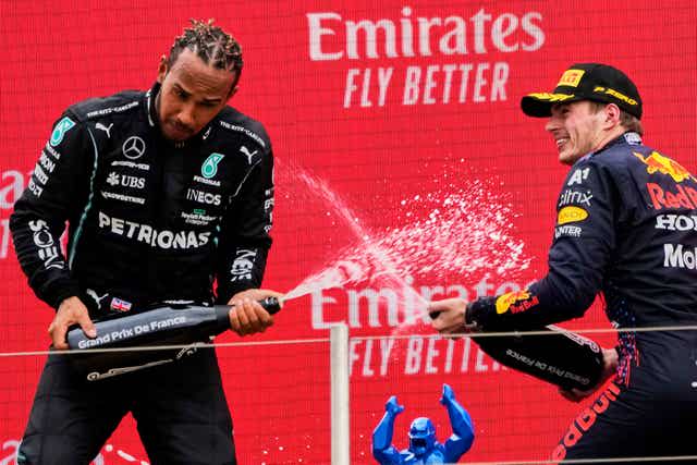 Red Bull driver Max Verstappen, right, celebrates with second-placed Mercedes driver Lewis Hamilton 