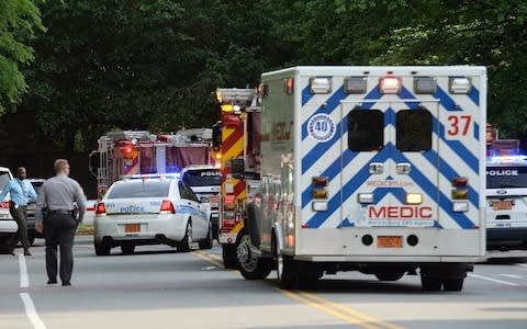 Emergency vehicles cluster on Mary Alexander Road on the campus of University of North Carolina - Credit: John Simmons/AP