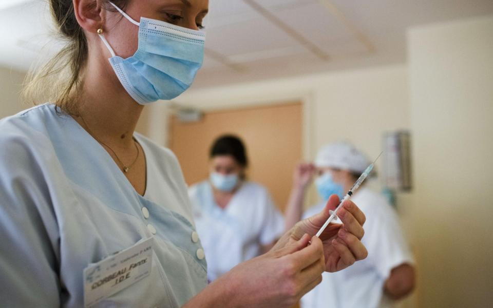 A healthcare worker prepares a dose of the Pfizer-BioNTech Covid-19 vaccine at the Ambroise Pare Clinic in Paris, France, on Wednesday, Jan. 6, 2021. - Nathan Laine/Bloomberg