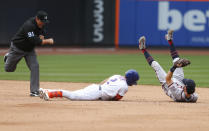 Umpire Brian Knight (91) calls New York Mets first baseman Dominic Smith (2) out at second base after the tag by Atlanta Braves shortstop Dansby Swanson (7) during the inning of a baseball game Thursday, July 29, 2021, in New York. (AP Photo/Noah K. Murray)
