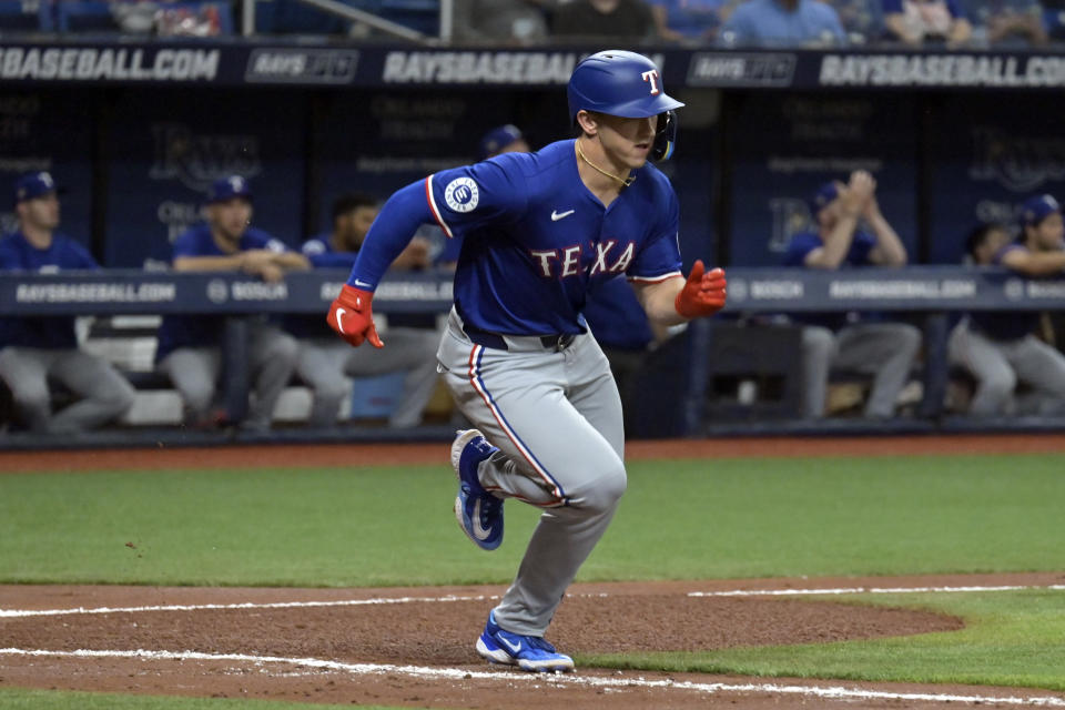 Texas Rangers' Wyatt Langford takes off for first base after hitting a single to center field off Tampa Bay Rays starter Ryan Pepiot during the fourth inning of a baseball game Monday, April 1, 2024, in St. Petersburg, Fla. (AP Photo/Steve Nesius)