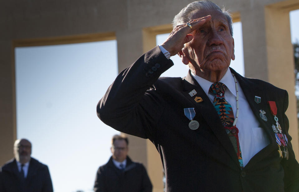 Charles Norman Shay, D-Day WWII veteran and Penobscot Elder from Maine, salutes after laying a wreath during a D-Day 76th anniversary ceremony at the Normandy American Cemetery in Colleville-sur-Mer, Normandy, France, Saturday, June 6, 2020. Due to coronavirus measures many ceremonies and memorials have been cancelled in the region with the exception of very small gatherings. (AP Photo/Virginia Mayo)