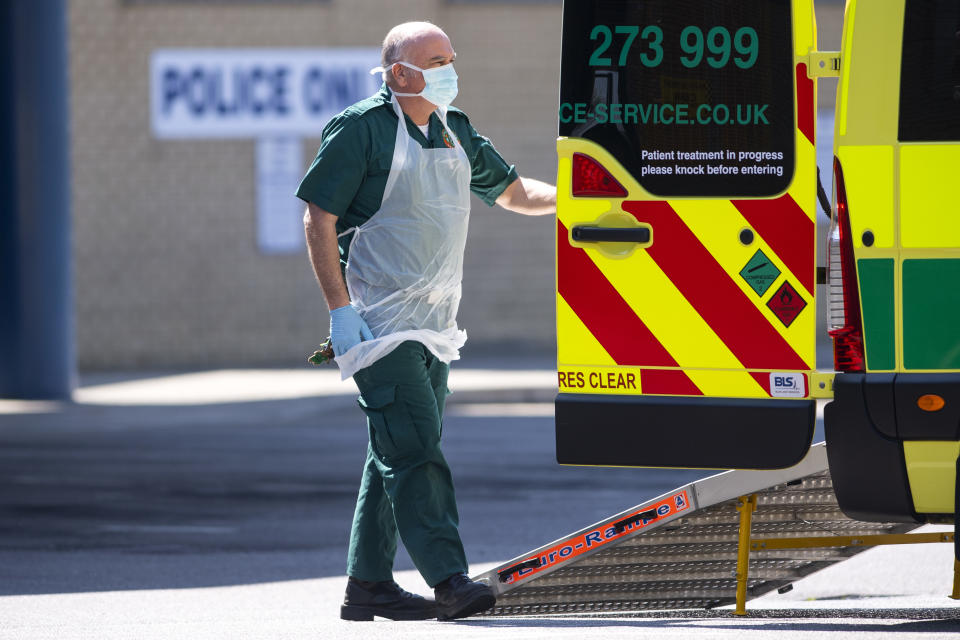 LONDON, UNITED KINGDOM - APRIL 21: London Ambulance staff waring PPE help a patient with an unknown condition from an ambulance at Queens Hospital on April 21, 2020 in London, England. The British government has extended the lockdown restrictions first introduced on March 23 that are meant to slow the spread of COVID-19. (Photo by Justin Setterfield/Getty Images)