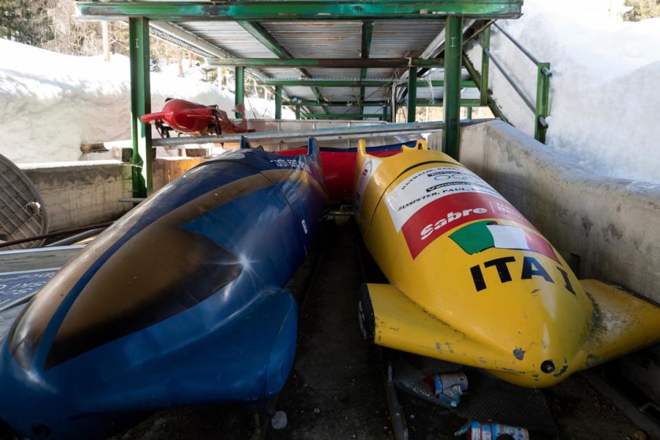 Bobsleds are parked next to the track in Cortina d'Ampezzo, Italy, (AP)