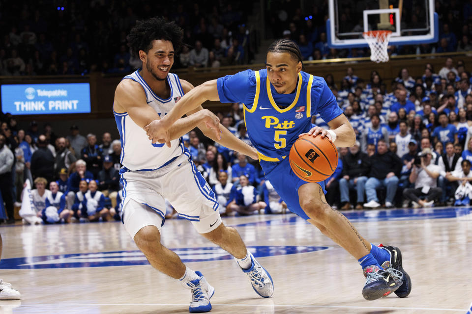 Pittsburgh's Ishmael Leggett (5) drives as Duke's Jared McCain, left, defends during the first half of an NCAA college basketball game in Durham, N.C., Saturday, Jan. 20, 2024. (AP Photo/Ben McKeown)