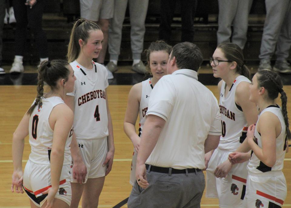 Cheboygan's starting five of Jaelyn Wheelock, Bella Ecker, Emily Clark, Cloee Rupp and Olivia Patrick listens to coach Walter Hanson before the start of Tuesday's game against Newberry.