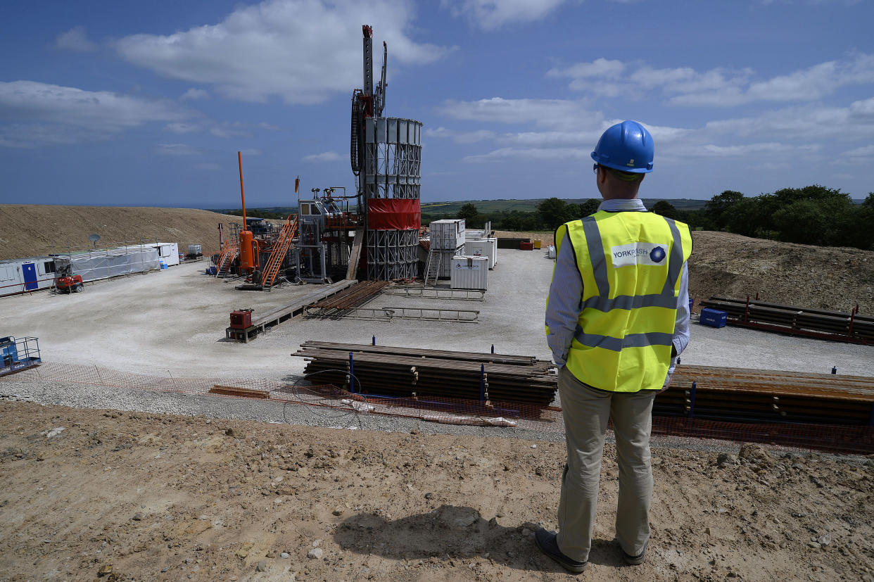 An employee poses for a photograph at the Sirius Minerals test drilling station on the North Yorkshire Moors near Whitby, northern England July 5, 2013. Sirius Minerals, is planning one of the world's largest potash mines in response to booming global demand for the crop fertilizer, within the North York Moors National Park boundaries.  "There's a huge amount of paper work to deal with. Everyone's watching; there's pressure on both sides," operations director Graham Clarke told Reuters at the drill site near the coastal town of Whitby, where a large red rig pierces a clear summer sky. Photograph taken on July 5, 2013.  REUTERS/Nigel Roddis (BRITAIN - Tags: BUSINESS ENERGY ENVIRONMENT)