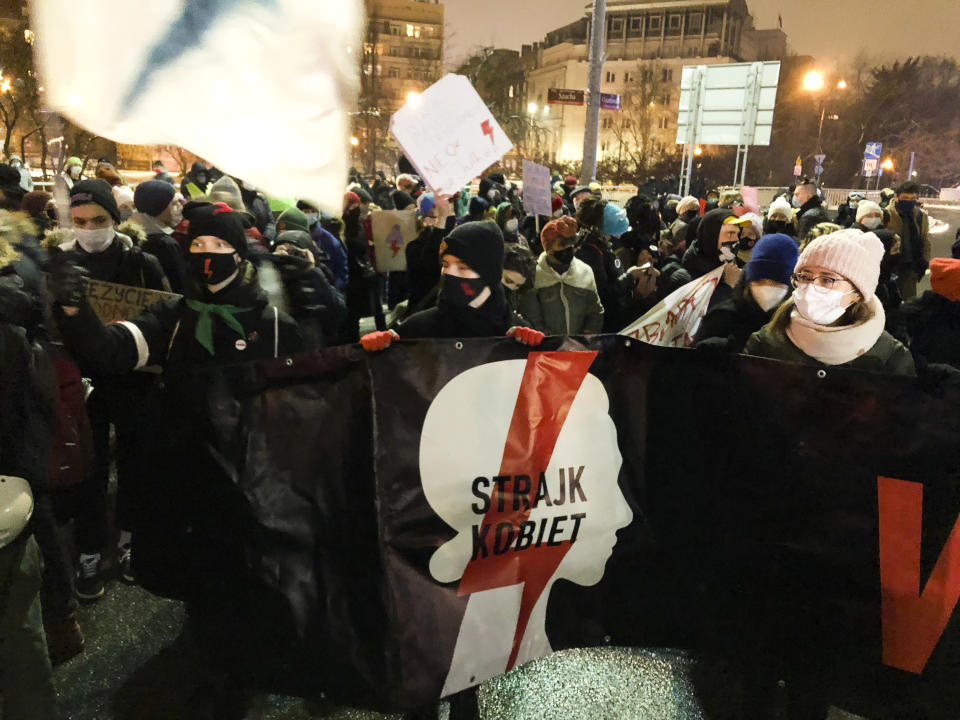 People show a poster reading: 'Women's Strike' as they attend a protest against a strict anti-abortion law in Warsaw, Poland, Thursday, Jan. 28, 2021. A near total ban on abortion has finally taken effect in Poland three months after a top court ruled that the abortion of congenitally damaged fetuses is unconstitutional, a move that has sparked a new round of nationwide protests. (Photo/Czarek Sokolowski)