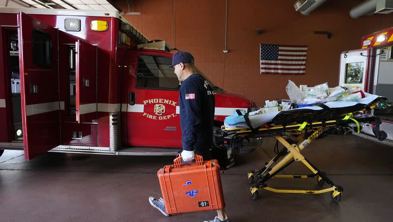 Phoenix Fire Department firefighter John Cooley walks with gear inside Phoenix Fire Department Station 61 as temperatures were expected to hit 116 degrees on  July 18, 2023, in Phoenix. Researchers say extreme heat and high pollution levels are linked to a greater risk of heart attacks,
