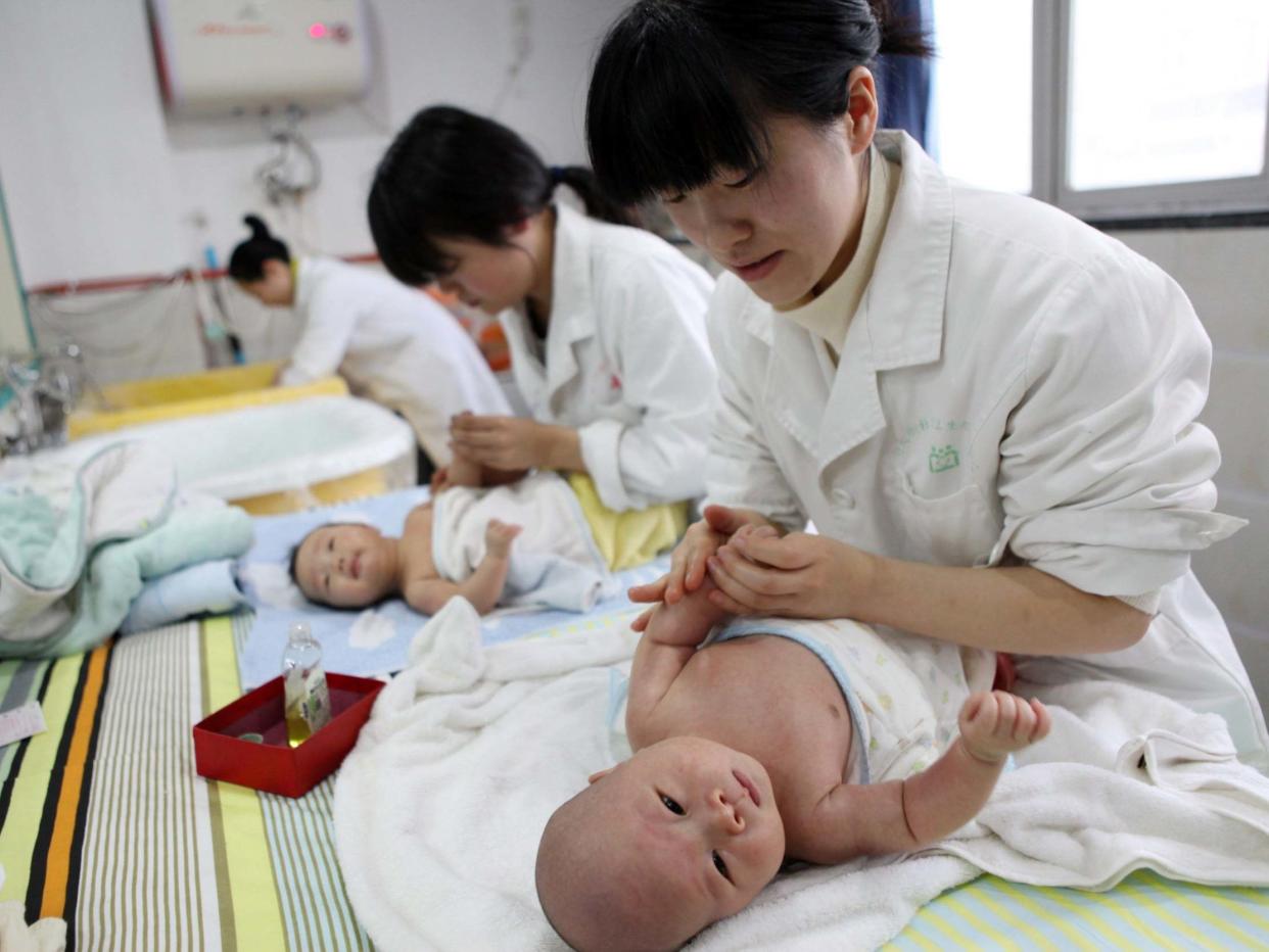 Nurses look after babies at an infant care centre in Yongquan, southwest China: AFP via Getty Images