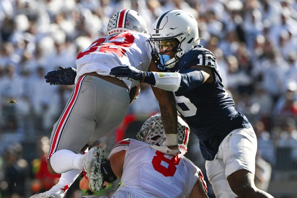 Penn State safety Ji'Ayir Brown (16) tackles Ohio State running back TreVeyon Henderson (32) during the first half of an NCAA college football game, Saturday, Oct. 29, 2022, in State College, Pa. (AP Photo/Barry Reeger)