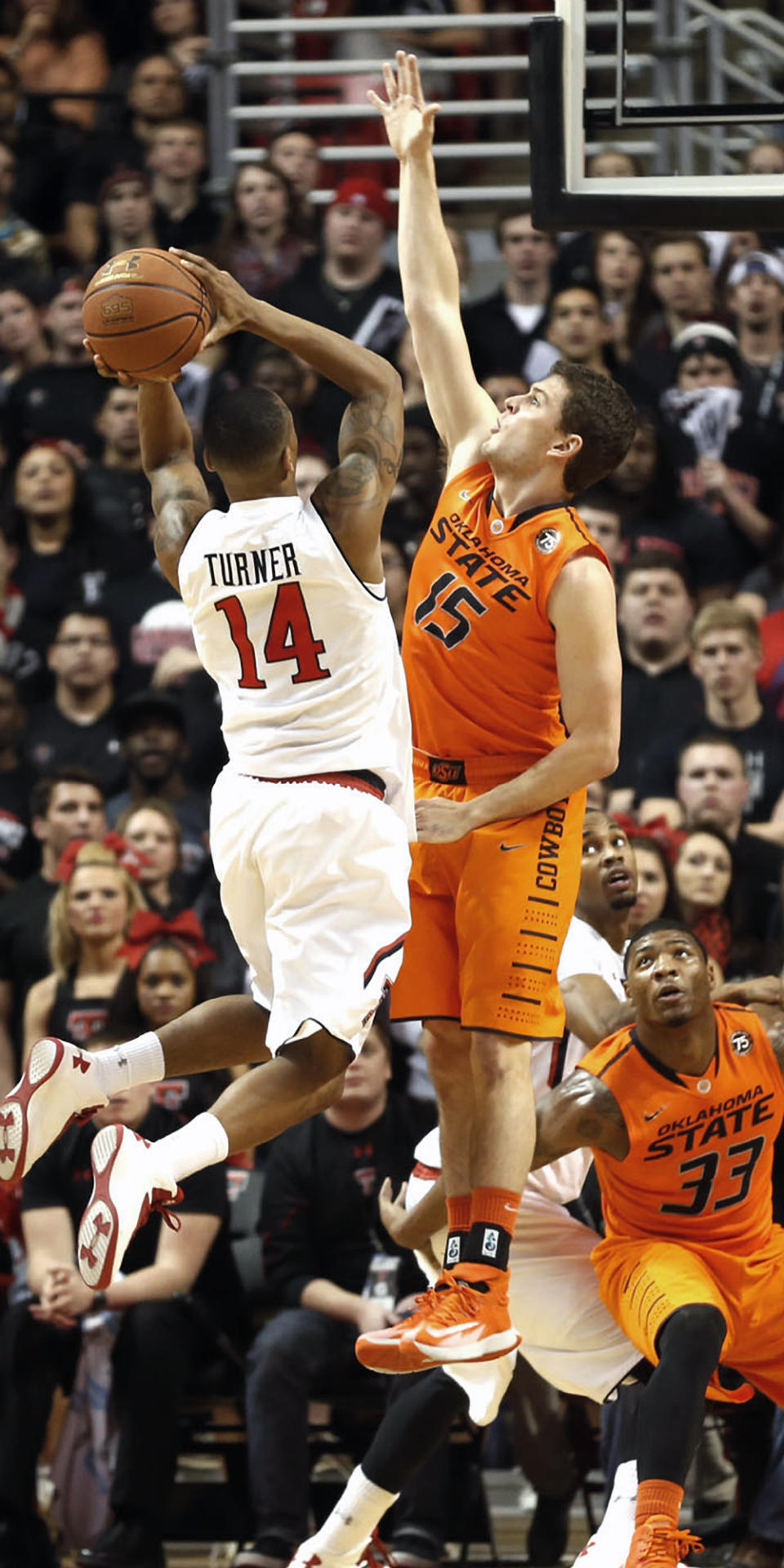 Texas Tech's Robert Turner (14) tries to drive past Oklahoma State's Christien Sager (15) during their NCAA college basketball game in Lubbock, Texas, Saturday, Feb, 8, 2014. (AP Photo/Lubbock Avalanche-Journal, Tori Eichberger) ALL LOCAL TV OUT