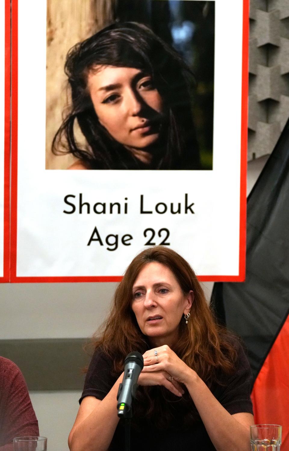 Ricarda Louk sits in front of a placard of her daughter Shani Louk Tuesday Oct. 17, 2023 in Tel Aviv.