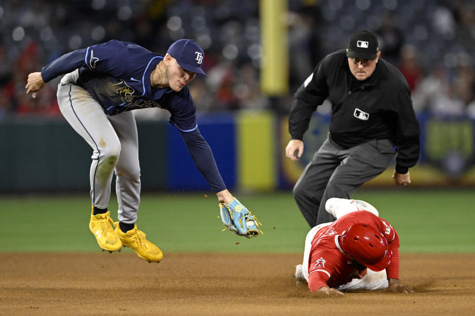 Los Angeles Angels' Anthony Rendon, right, steals second base as Tampa Bay Rays second baseman Curtis Mead, left, misses the tag during the third inning of a baseball game in Anaheim, Calif., Tuesday, April 9, 2024. (AP Photo/Alex Gallardo)
