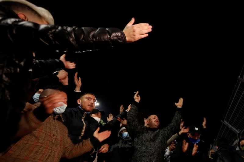 People gather to mourn the death of Argentine soccer legend Diego Maradona, in Naples