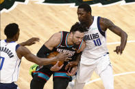 Memphis Grizzlies forward Dillon Brooks drives between Dallas Mavericks forward Dorian Finney-Smith (10) and guard Josh Richardson (0) during the first half of an NBA basketball game Tuesday, May 11, 2021, in Memphis, Tenn. (AP Photo/Wade Payne)