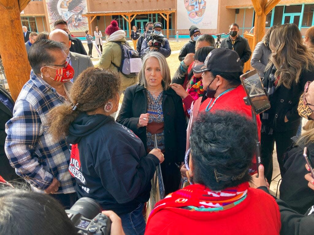 Family members of missing and slain Native Americans talk with New Mexico Gov. Michelle Lujan Grisham, center, after she signed legislation during a ceremony in Albuquerque, N.M. on Thursday, Feb. 24, 2022. New Mexico's Democratic governor says she believes vetting of her Cabinet members is crucial. But with two weeks remaining in the legislative session, she has yet to submit her nominee to oversee the state Indian Affairs Department to the Senate.