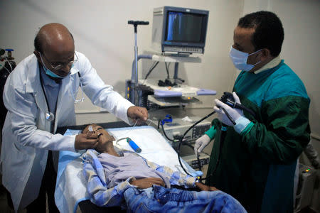 Doctors check malnourished Ghazi Ahmad, 10, at a hospital in Taiz, Yemen November 3, 2018. Picture taken November 3, 2018. REUTERS/Anees Mahyoub