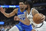 Brooklyn Nets' Trendon Watford gets past Milwaukee Bucks' Giannis Antetokounmpo during the first half of an NBA basketball game Thursday, March 21, 2024, in Milwaukee. (AP Photo/Morry Gash)