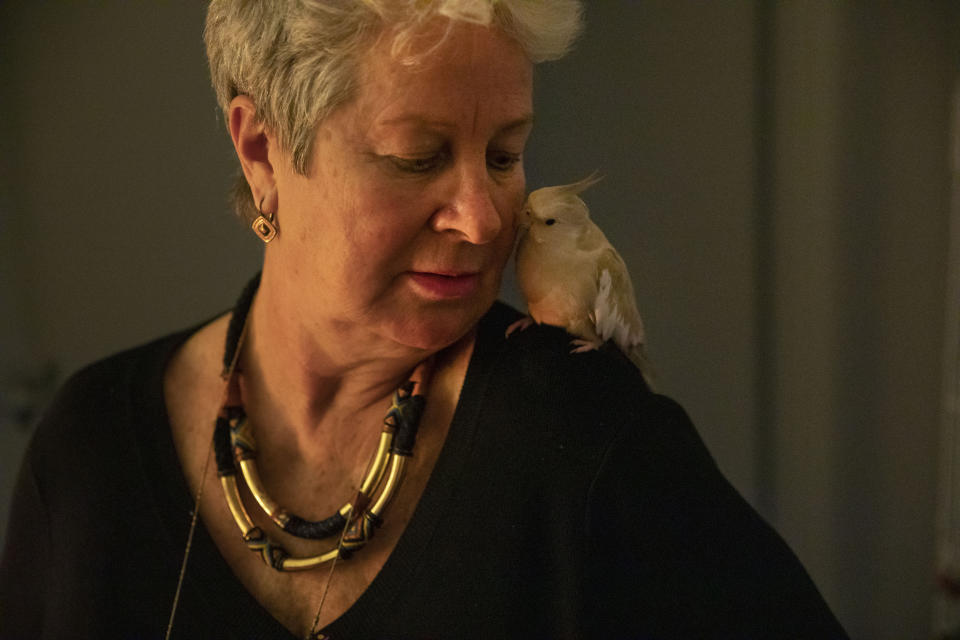 Deb Ware looks after Yazoo, her son's cockatiel, whom she's been looking after since her son has struggled with an opioid addiction, in Fountaindale, Central Coast, Australia, Thursday, July 18, 2019. Her son, Sam, has survived more than 60 overdoses in 12 months. (AP Photo/David Goldman)