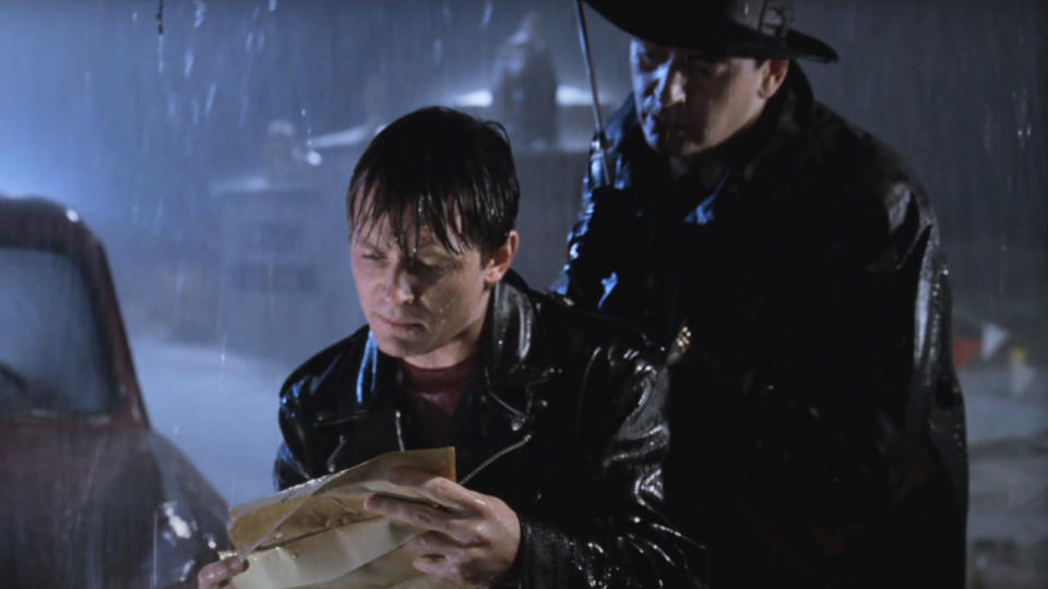 Michael J Fox reads a telegram with Joe Flaherty over his shoulder in Back To The Future: Part II.