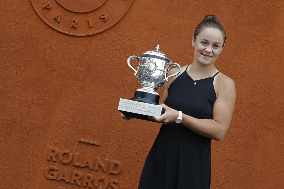 Australia's Ashleigh Barty poses with the trophy during a photo call at the Roland Garros stadium in Paris, Sunday, June 9, 2019. Barty won the French Open tennis tournament women's final on Saturday June 8, 2019. (AP Photo/Michel Euler)