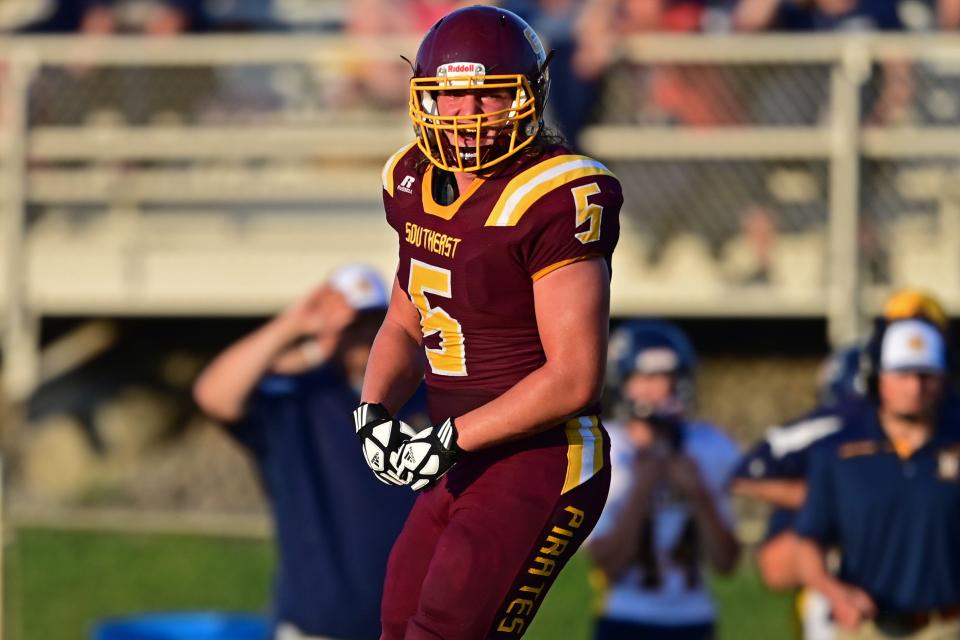 Southeast's Spencer Mesaros celebrates after a tackle in the backfield during the first half of their game Thursday night at Southeast High School. Southeast won 40-14.