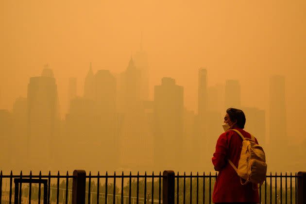 A person wears a face mask as smoke from wildfires in Canada cause hazy conditions in New York City on June 7, 2023. 