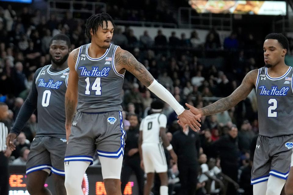 Seton Hall guards Dylan Addae-Wusu (0), Dre Davis (14) and Al-Amir Dawes (2) celebrate as Seton Hall leads Providence during the second half of an NCAA college basketball game Wednesday, Jan. 3, 2024, in Providence, R.I. (AP Photo/Steven Senne)