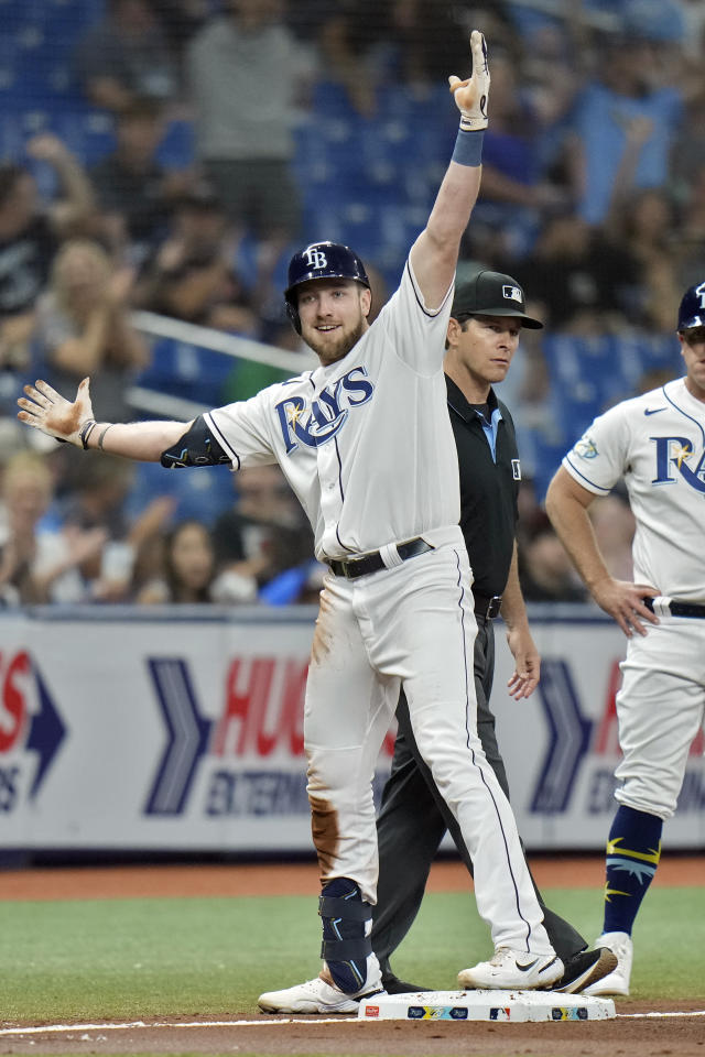 Tampa Bay Rays pitchers Josh Fleming, left to right, Zach Eflin and Shane  McClanahan laugh in the dugout after watching infielder Luke Raley pitch  during a baseball game against the Toronto Blue