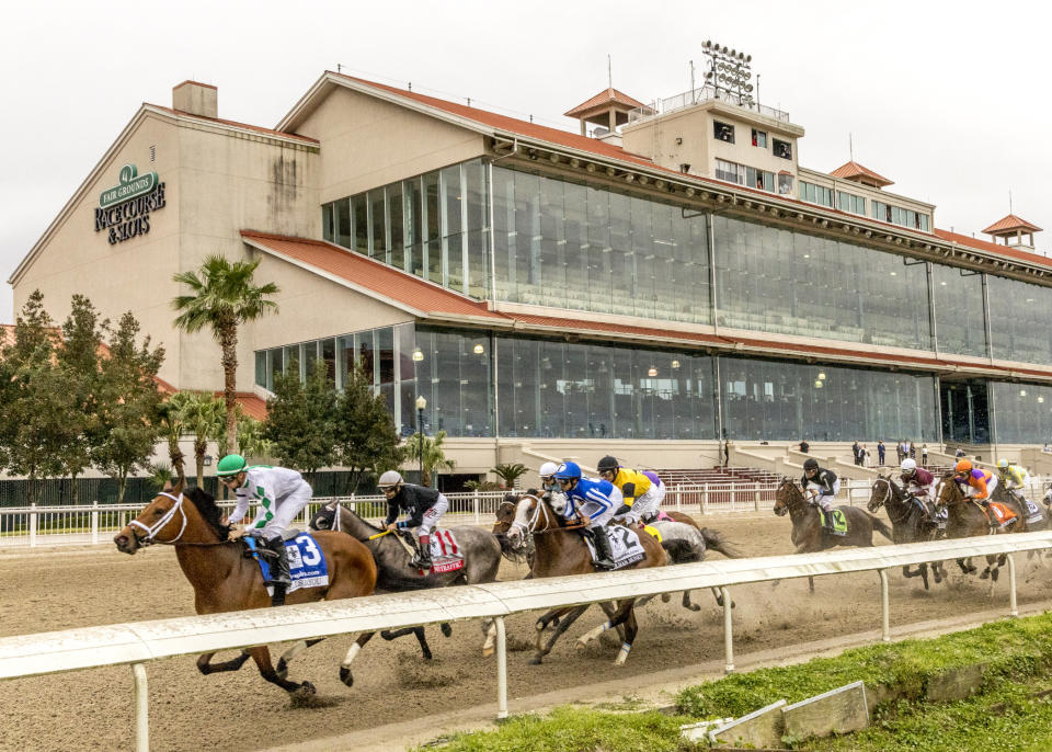 Wells Bayou, left, ridden by jockey Florent Geroux, took an early lead and held off NY Traffic to win he 107th running of the $1,000,000 Grade II Louisiana Derby horse race, Saturday, March 21, 2020, at a fanless Fair Grounds race course in New Orleans. (Amanda Hodges Weir/Hodges Photography, Fair Grounds Race Course via AP)