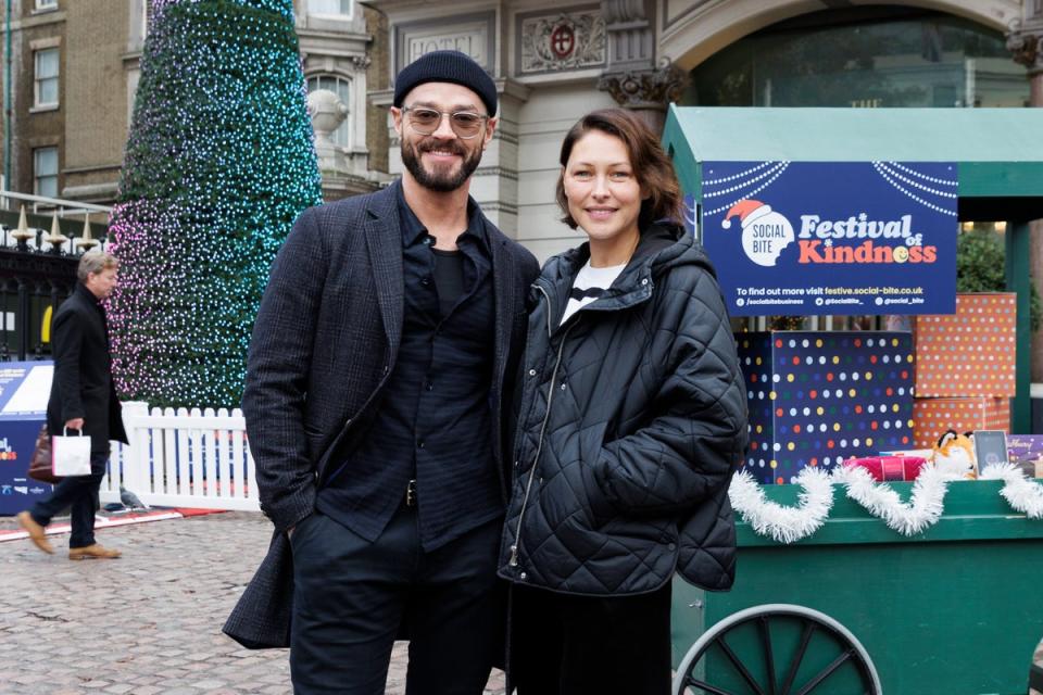 Social Bites's Festival of Kindness Helping Homeless & Vulnerable People at Christmas: Matt Willis and Emma Wills are pictured at the ‘Tree of Kindness’ during the launch of Social Bite’s Festival of Kindness at Charing Cross Station on November 28, 2022 in London, England. Social Bite’s Festival of Kindness is helping homeless and vulnerable people across the UK through the cost-of-living crisis this Christmas. To help Social Bite in providing meals, gifts, packs of essential items, and emergency accommodation with support to people in need, members of the public can donate a ‘Christmas of Kindness’.  (Photo by John Phillips/Getty Images for Social Bite Fund) (Getty Images for Social Bite Fun)