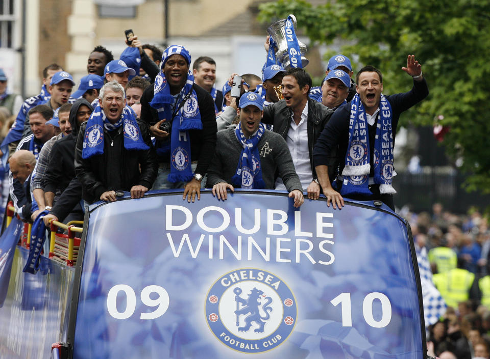 Chelsea's Captain John Terry (R), English midfielder Frank Lampard (2ndR), Czech goalkeeper Petr Cech (C) and Ivory Coast striker Didier Drogba (L) show off the Barclays Premiership Trophy and FA Cup during their victory parade at Stamford Bridge, London, England, on May 16, 2010. Didier Drogba insists Chelsea's Premier League and FA Cup double triumph means this season has been the best of his career. Drogba scored the only goal of the game in the FA Cup final against Portsmouth to secure a first ever double for the west London club. AFP PHOTO/GLYN KIRK (Photo credit should read GLYN KIRK/AFP/Getty Images)