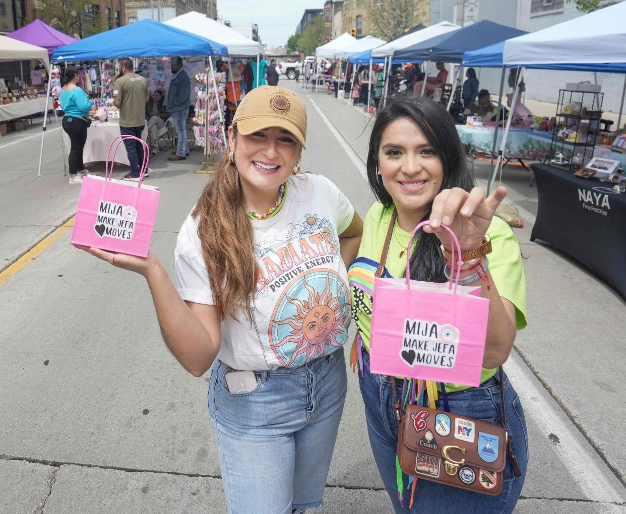 Nataly Andrade and Galy Montes hold up a bag that means 'Girl, Make boss moves' in English. They are the founders of Mercadera Market and host throughout different locations in Milwaukee. The Mercadera Market is an online community that supports Latina small businesses and entrepreneurs in Milwaukee. They were at Makers Market at Indeed Brewing Company Saturday, May 13, 2023 in Milwaukee. 'Being apart of the businesses future,' they expressed is their favorite part. 'Building a community and being a family, knowing that we help others is rewarding especially since it is Latinas.'