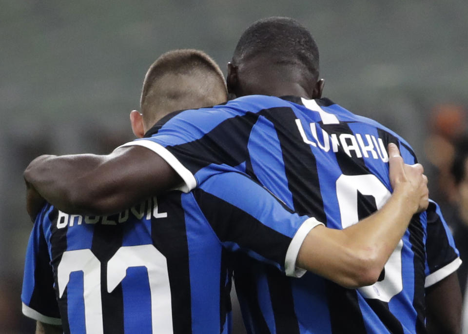 Inter Milan's Romelu Lukaku, right, celebrates his goal with Inter Milan's Marcelo Brozovic during a Serie A soccer match between AC Milan and Inter Milan, at the San Siro stadium in Milan, Italy, Saturday, Sept.21, 2019. (AP Photo/Luca Bruno)