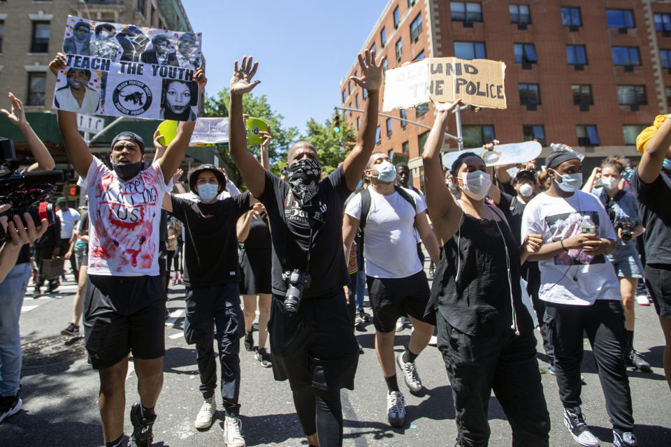 Protesters march through the streets of Harlem during a solidarity rally for George Floyd, Saturday, May 30, 2020, in New York. Floyd died after Minneapolis police officer Derek Chauvin pressed his knee into his neck for several minutes even after he stopped moving and pleading for air. (AP Photo/Mary Altaffer)