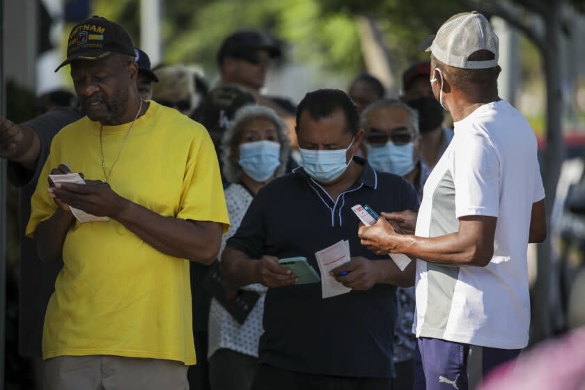 Hawthorne, CA - July 29: People stand in line to purchase tickets for Mega Millions lottery as jackpot tops $1 billion at Bluebird Liquor on Friday, July 29, 2022 in Hawthorne, CA. (Irfan Khan / Los Angeles Times)