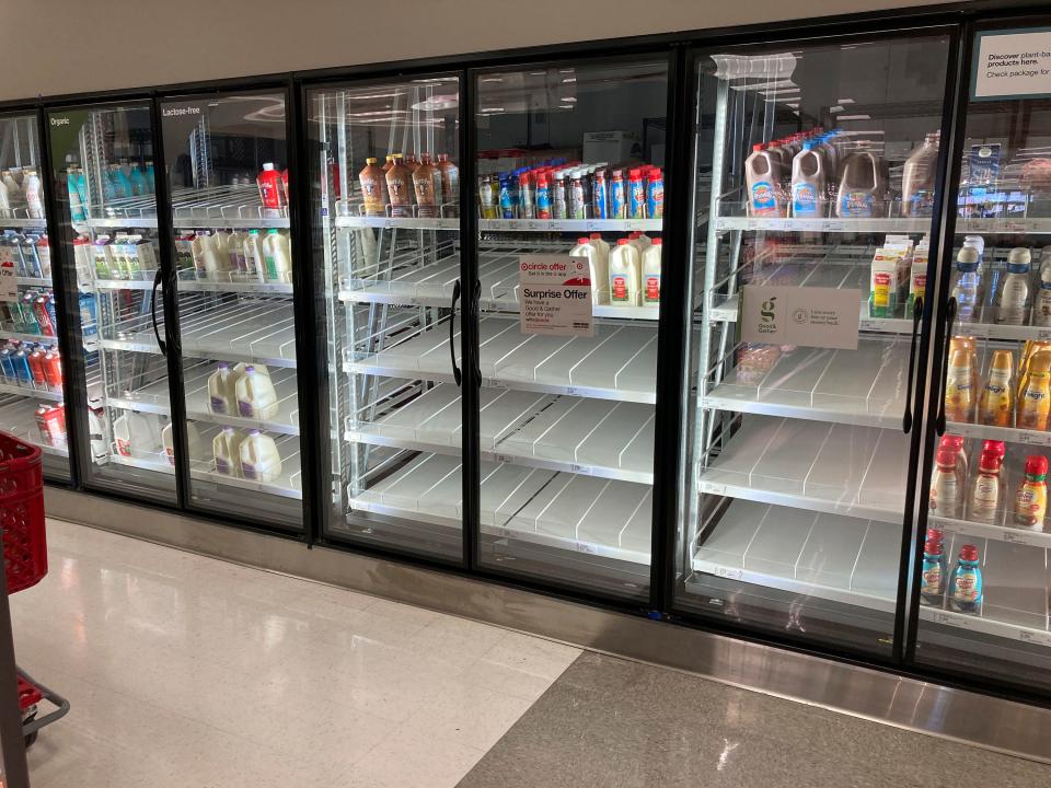 Hold For Biz—Empty Shelves—Shelves sit without stock in the dairy case of a Target store Saturday, Jan. 15, 2022, in southeast Denver. 